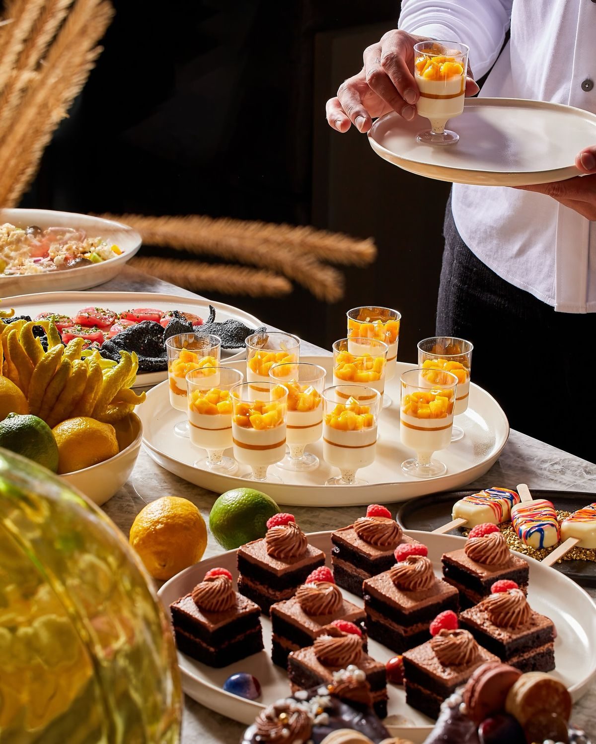 Dessert counter with mousse cups and chocolate cakes